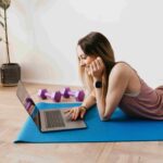 A woman wearing sport watch lying on a yoga mat