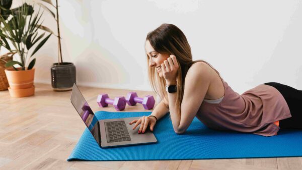 A woman wearing sport watch lying on a yoga mat