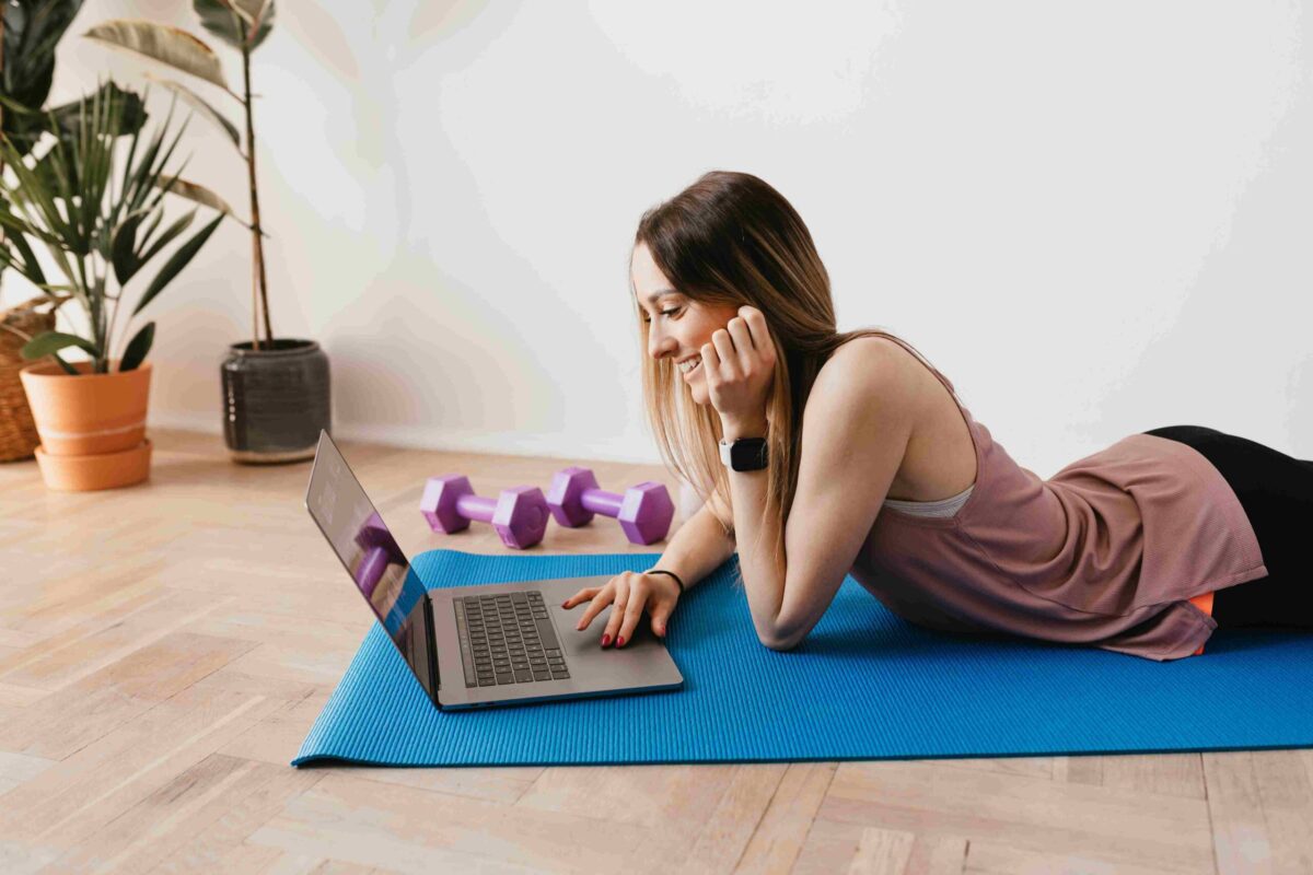 A woman wearing sport watch lying on a yoga mat