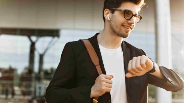 A man casually looking at his watch