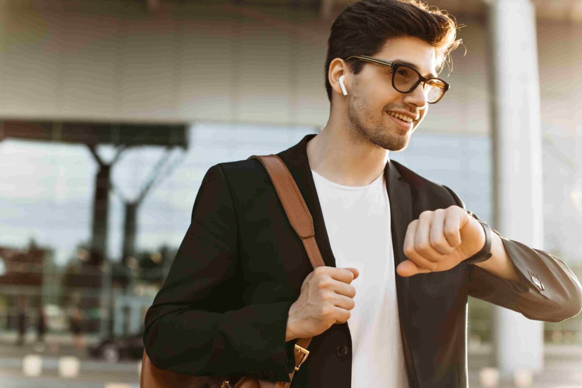 A man casually looking at his watch