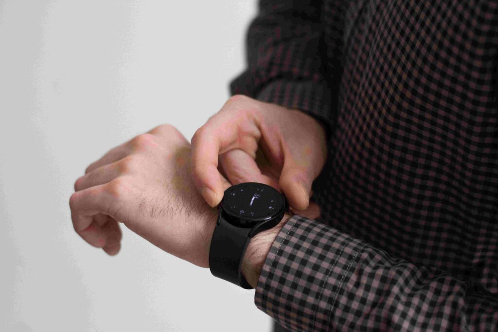 A closeup of man looking at his black watch