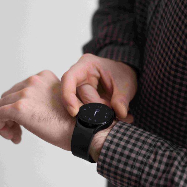 A closeup of man looking at his black watch