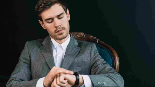 A man looking at his black classy executive watch
